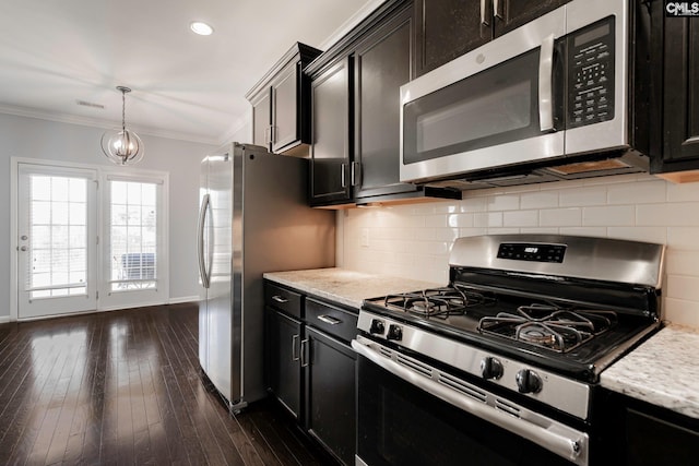 kitchen with pendant lighting, an inviting chandelier, ornamental molding, dark hardwood / wood-style flooring, and stainless steel appliances