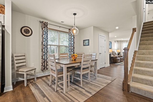 dining area with dark hardwood / wood-style floors