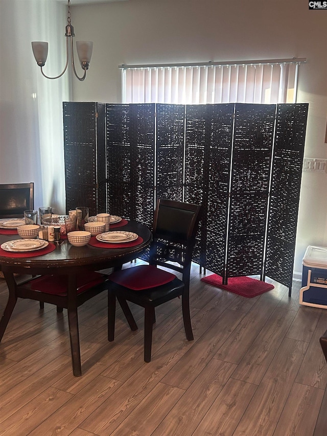 dining space with a chandelier and hardwood / wood-style flooring