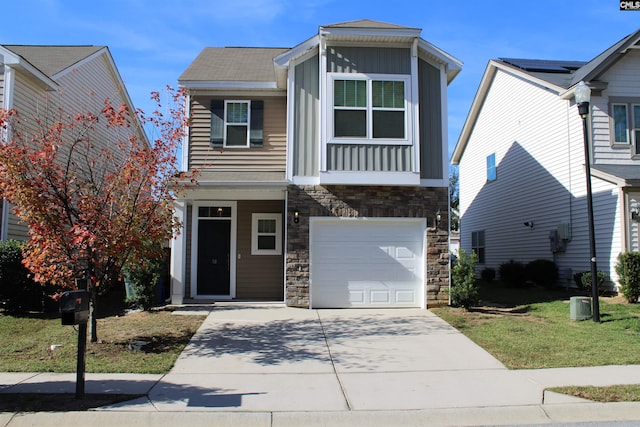 view of front facade with a garage and a front lawn