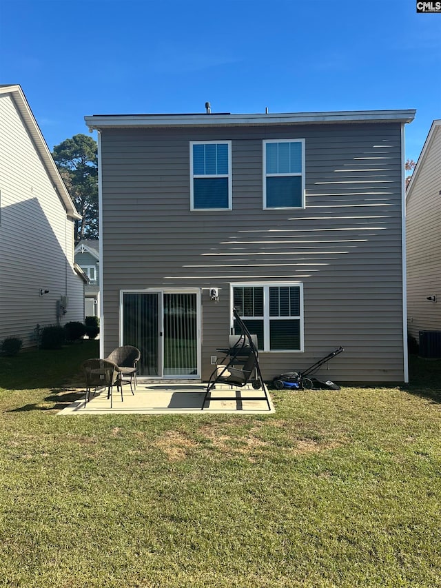 rear view of property featuring a yard, a patio, and central air condition unit