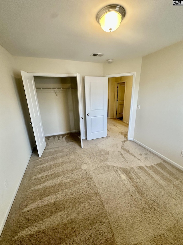 unfurnished bedroom featuring carpet flooring and a closet