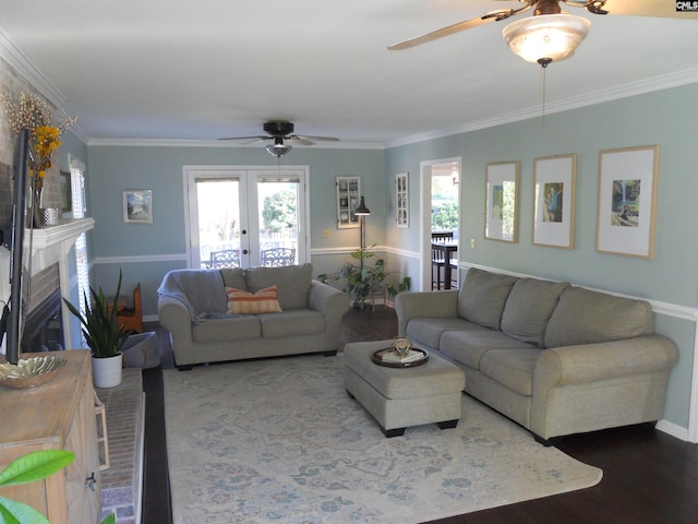 living room with hardwood / wood-style flooring, ornamental molding, a fireplace, and french doors