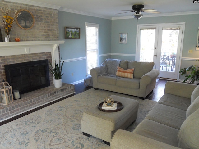 living room featuring ceiling fan, wood-type flooring, ornamental molding, and french doors