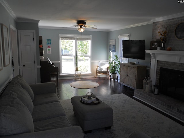 living room featuring a fireplace, wood-type flooring, ceiling fan, and ornamental molding