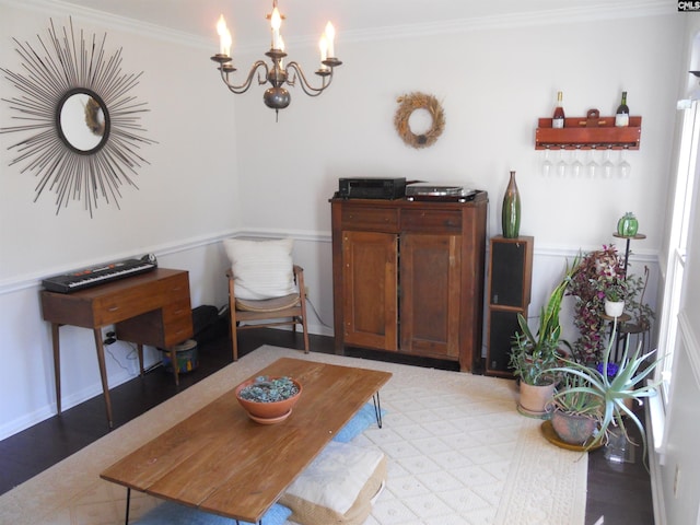 sitting room with a notable chandelier and crown molding