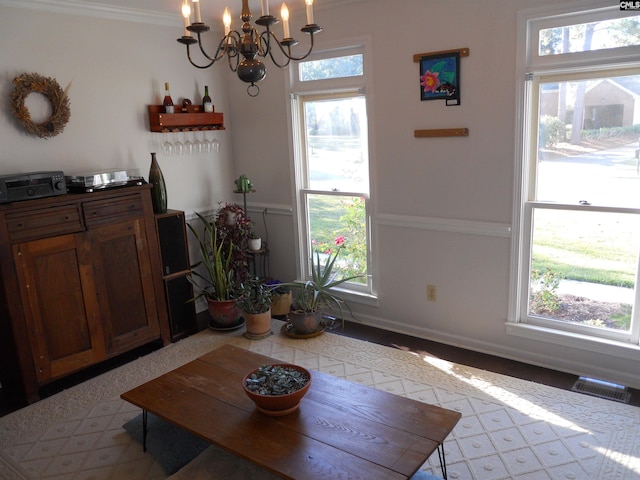 dining room featuring a wealth of natural light, a notable chandelier, and ornamental molding