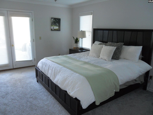 bedroom with light colored carpet, ornamental molding, french doors, and multiple windows