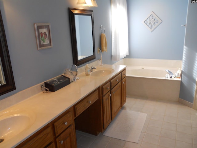 bathroom with tile patterned floors, a bathtub, and vanity