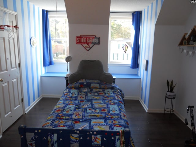 bedroom with dark wood-type flooring