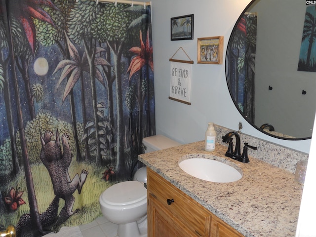 bathroom with tile patterned floors, vanity, and toilet