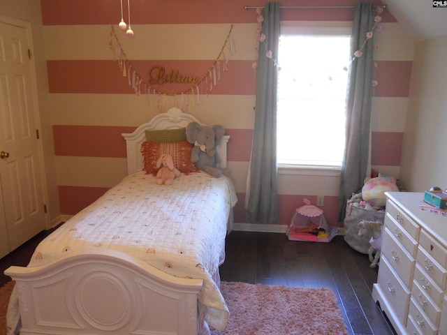 bedroom with multiple windows, dark wood-type flooring, and vaulted ceiling