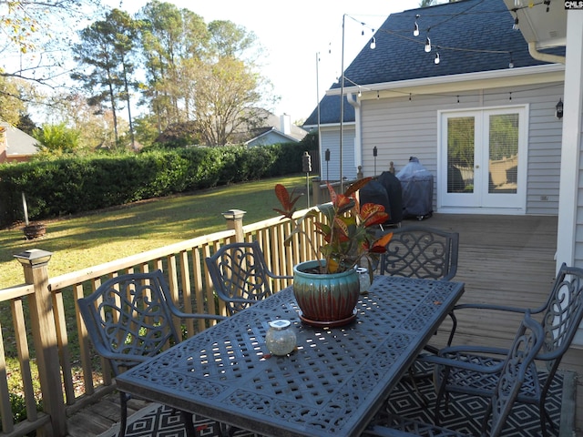 wooden terrace featuring a yard