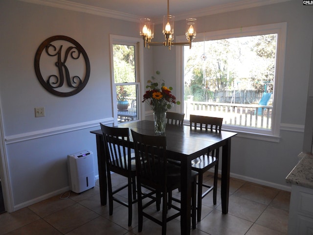 dining space featuring tile patterned flooring, a chandelier, and ornamental molding