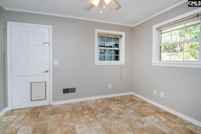 empty room with ceiling fan and crown molding