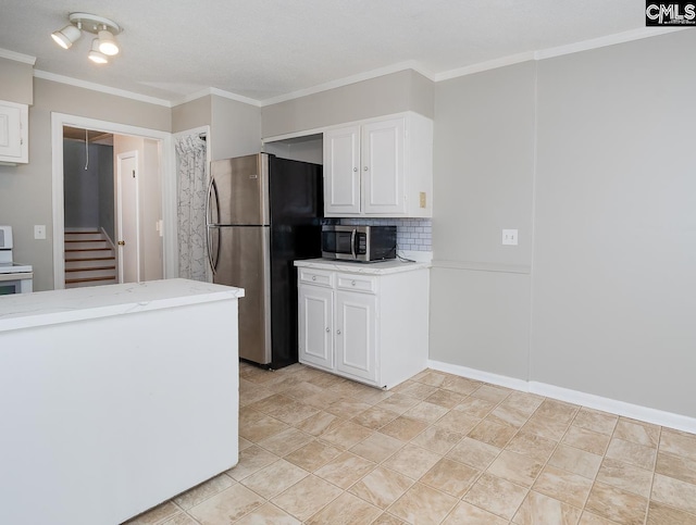 kitchen with tasteful backsplash, ornamental molding, stainless steel appliances, light tile patterned floors, and white cabinets