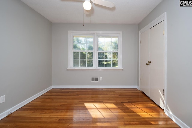 spare room with hardwood / wood-style flooring and ceiling fan