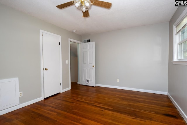 unfurnished bedroom featuring a textured ceiling, dark hardwood / wood-style flooring, and ceiling fan