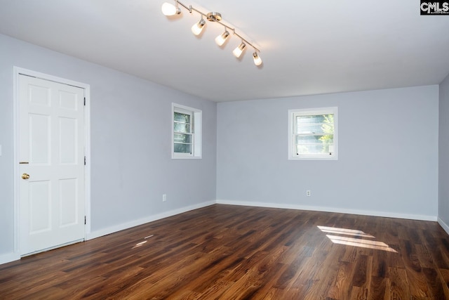 empty room featuring dark hardwood / wood-style flooring