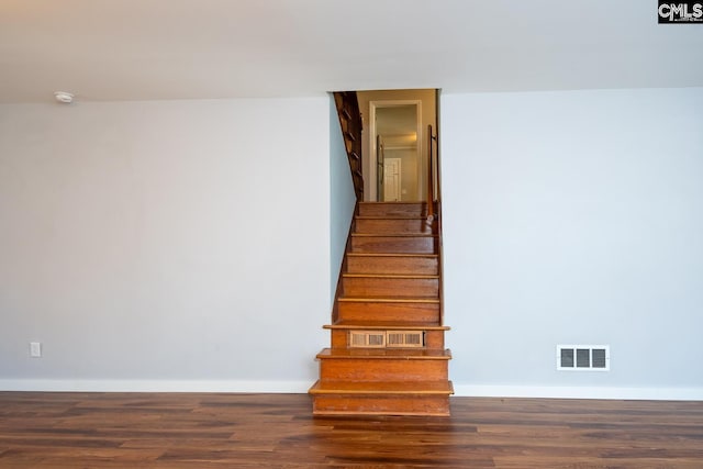 stairs featuring hardwood / wood-style flooring