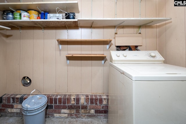 laundry room with washer / dryer and wooden walls