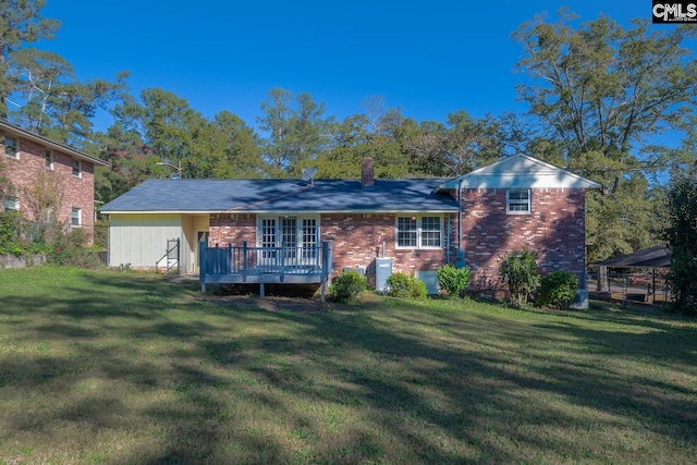 back of house featuring a yard and a wooden deck