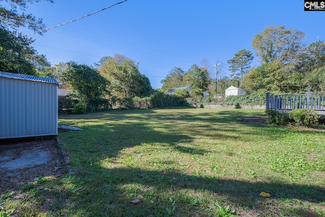 view of yard featuring a wooden deck