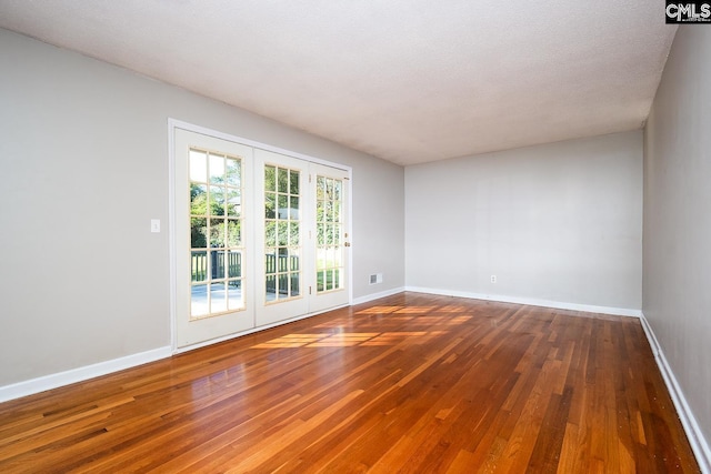 unfurnished room featuring dark hardwood / wood-style floors and a textured ceiling