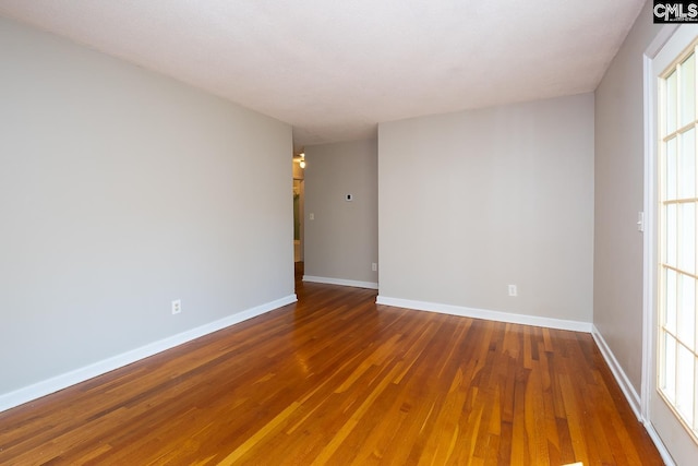 empty room featuring dark hardwood / wood-style flooring