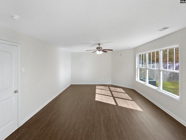 spare room with ceiling fan and dark hardwood / wood-style flooring