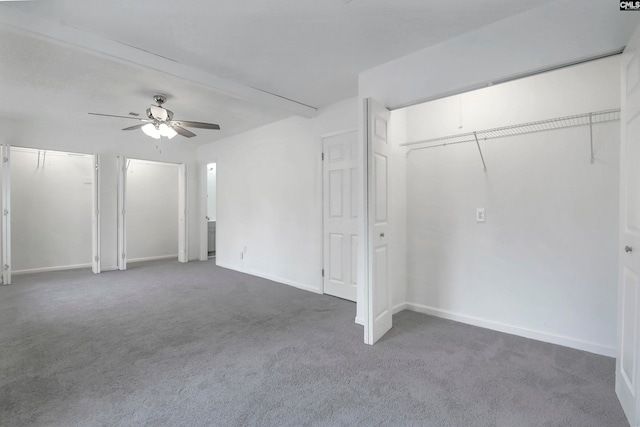 interior space featuring dark colored carpet and ceiling fan