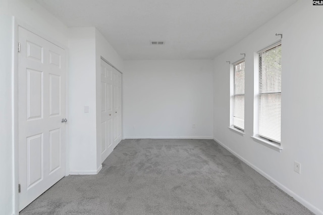 empty room featuring light colored carpet