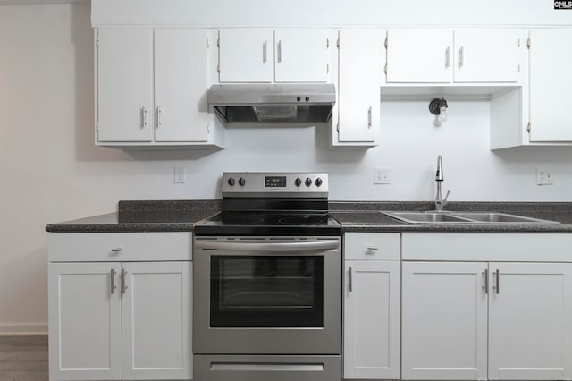 kitchen featuring white cabinets, electric range, hardwood / wood-style flooring, and sink