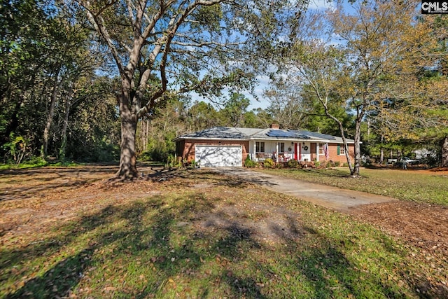 view of front of property with a garage and a front lawn