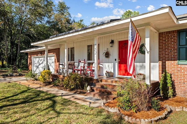 property entrance featuring a garage and covered porch