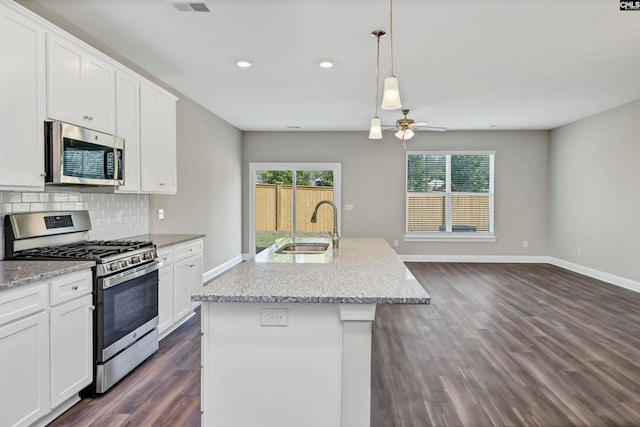 kitchen featuring white cabinets, a center island with sink, sink, appliances with stainless steel finishes, and dark hardwood / wood-style flooring