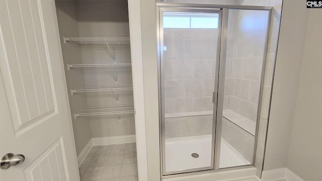 bathroom with tile patterned flooring and walk in shower