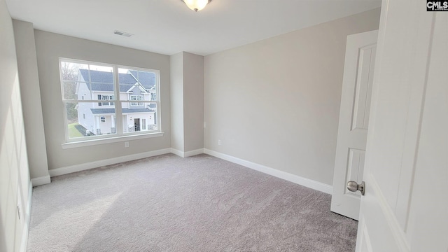 unfurnished room featuring light colored carpet