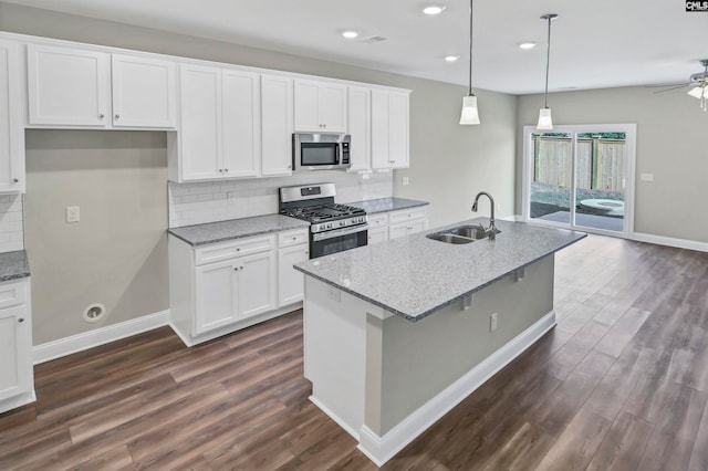 kitchen featuring white cabinets, light stone countertops, sink, and appliances with stainless steel finishes