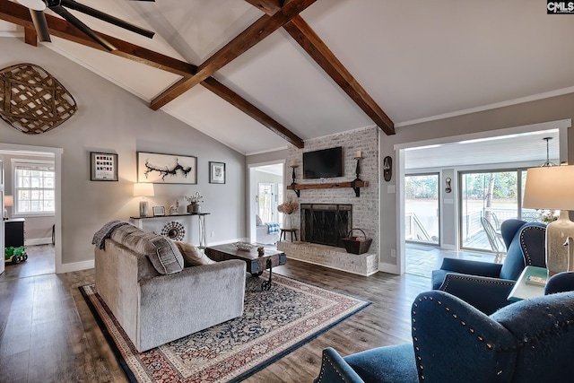 living room featuring dark hardwood / wood-style flooring, plenty of natural light, and lofted ceiling with beams