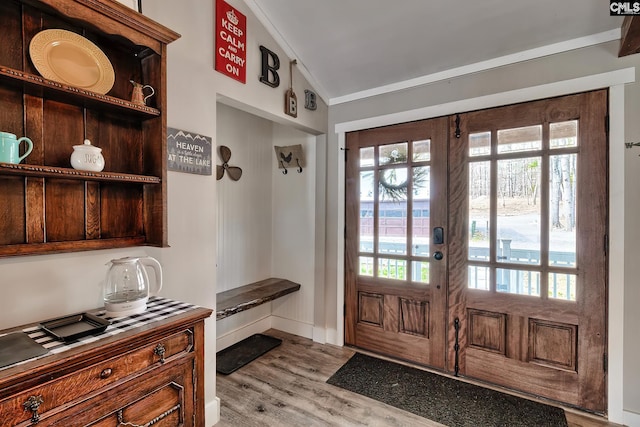 mudroom with light hardwood / wood-style floors, lofted ceiling, and crown molding