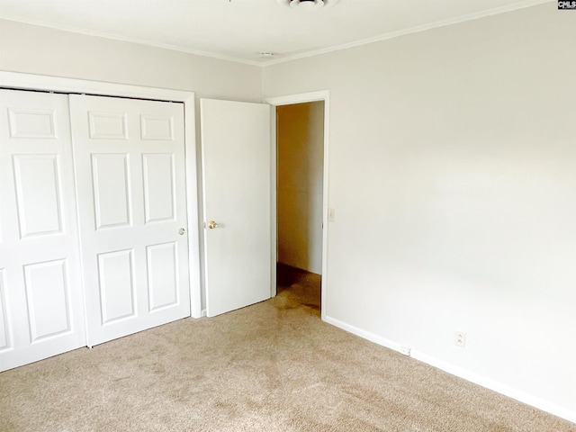 unfurnished bedroom featuring light colored carpet and a closet