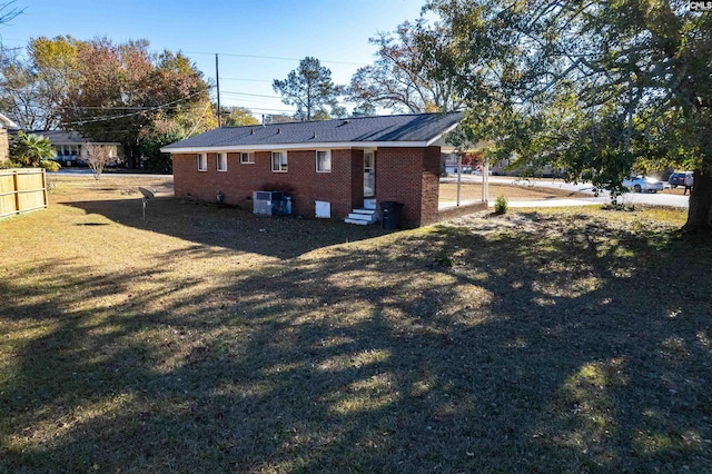 rear view of property featuring a lawn