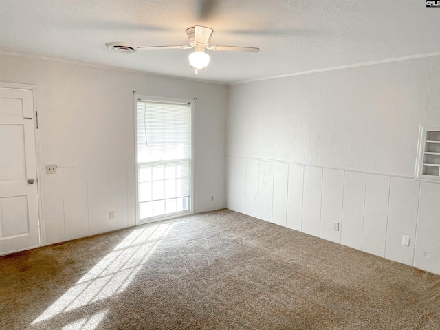 spare room with carpet flooring, ceiling fan, crown molding, and a textured ceiling