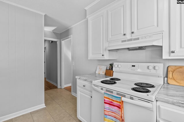 kitchen with electric stove, crown molding, light stone countertops, light tile patterned floors, and white cabinetry