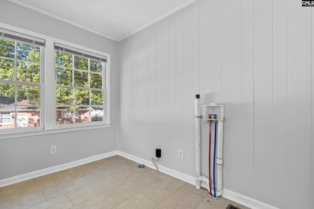 washroom with wooden walls, ornamental molding, a wealth of natural light, and washer hookup