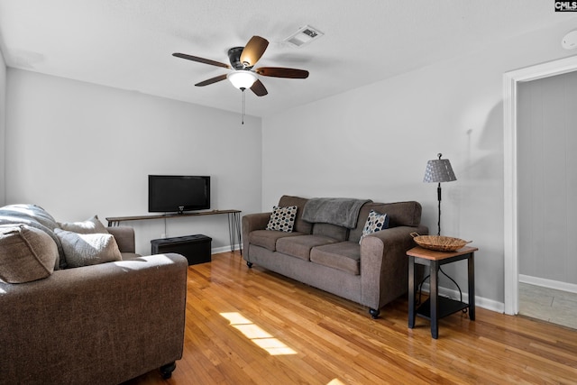 living room featuring hardwood / wood-style flooring and ceiling fan