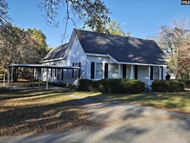 view of property exterior with a carport and a lawn