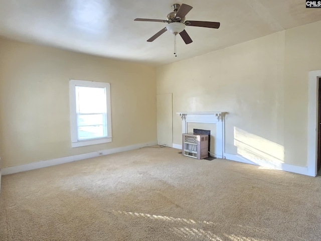 unfurnished living room featuring carpet flooring and ceiling fan