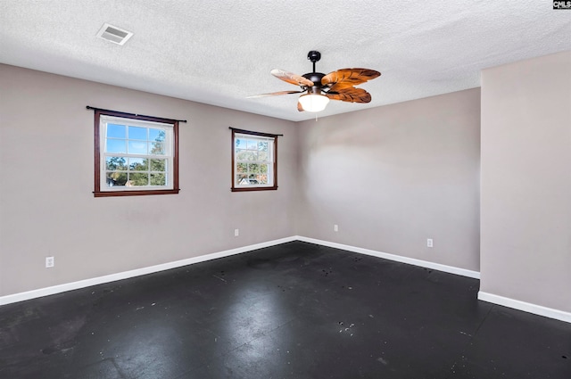 spare room featuring ceiling fan and a textured ceiling